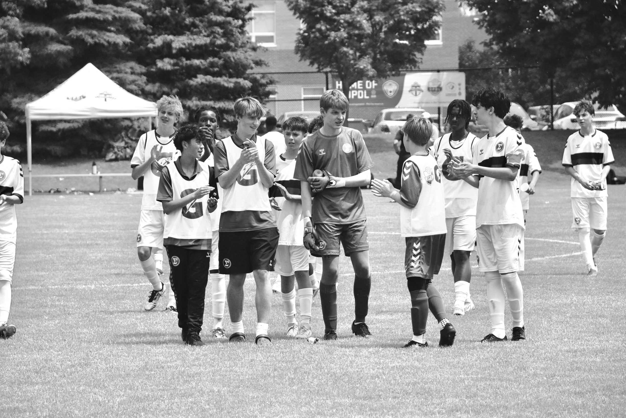 A youth soccer player performing dynamic warm-ups on a pitch in Hamilton.