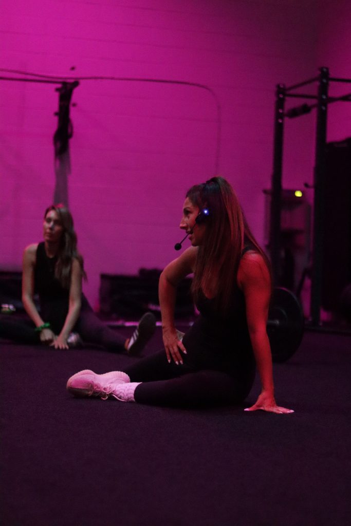 A professional personal trainer providing coaching cues to a client during a workout in Hamilton.