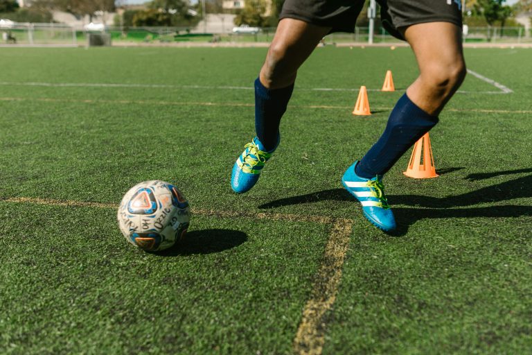 Youth soccer player practicing at home with soccer training equipment