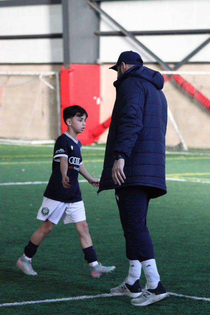 youth soccer player approaching his car