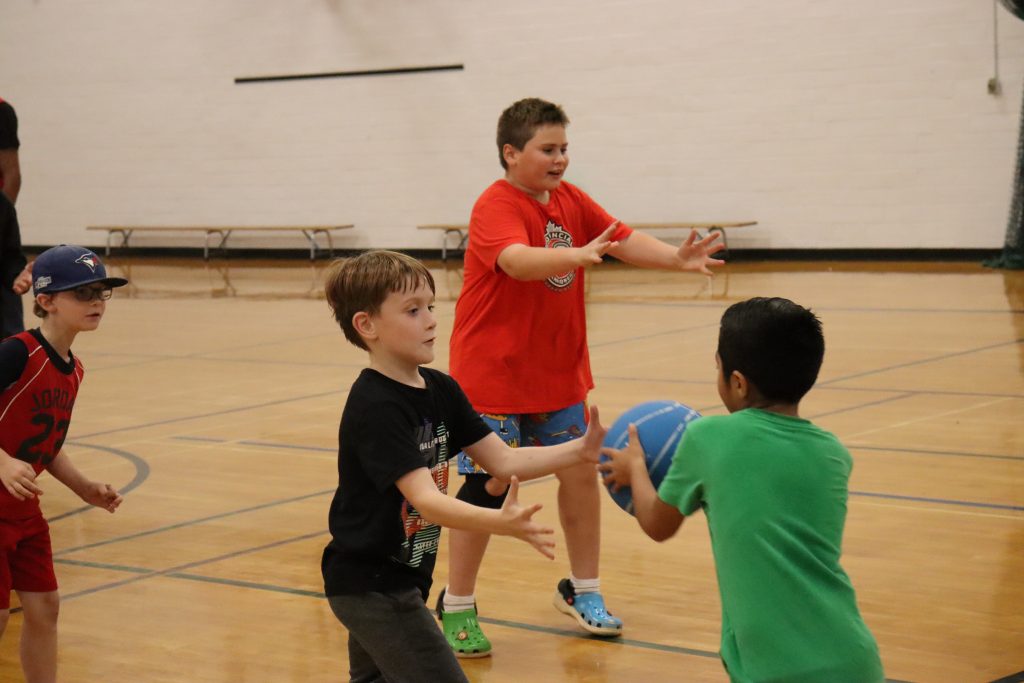Youth basketball players competing in a Free Play for Kids community match.